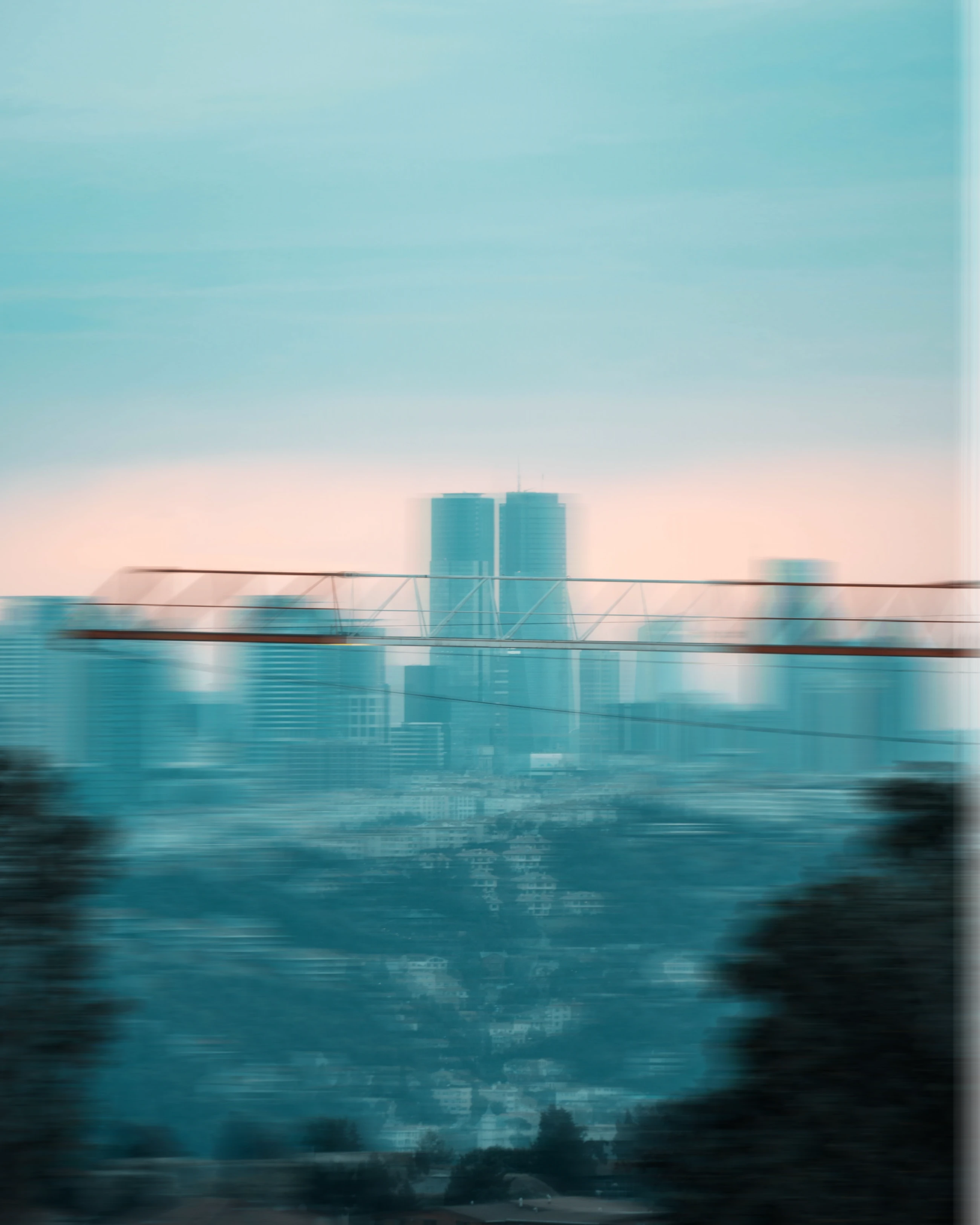 Tower crane jib above a city skyline at dusk